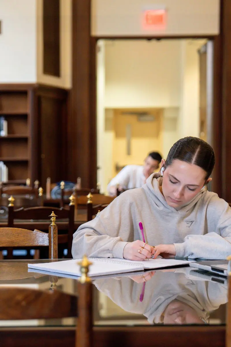 Student taking notes in the downtown library