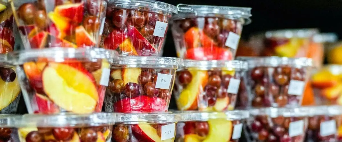 cups of fresh cut fruit including grapes and apples