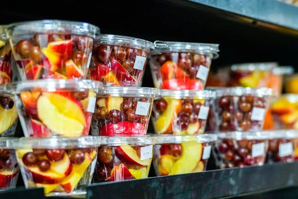 cups of fresh cut fruit including grapes and apples