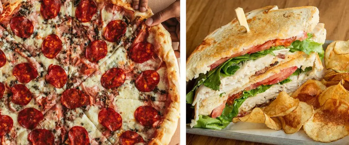 hands grabbing pizza and a sandwich with chips