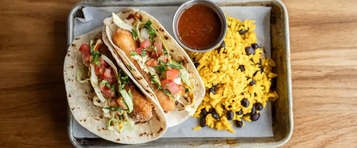 overhead image of fish tacos and rice