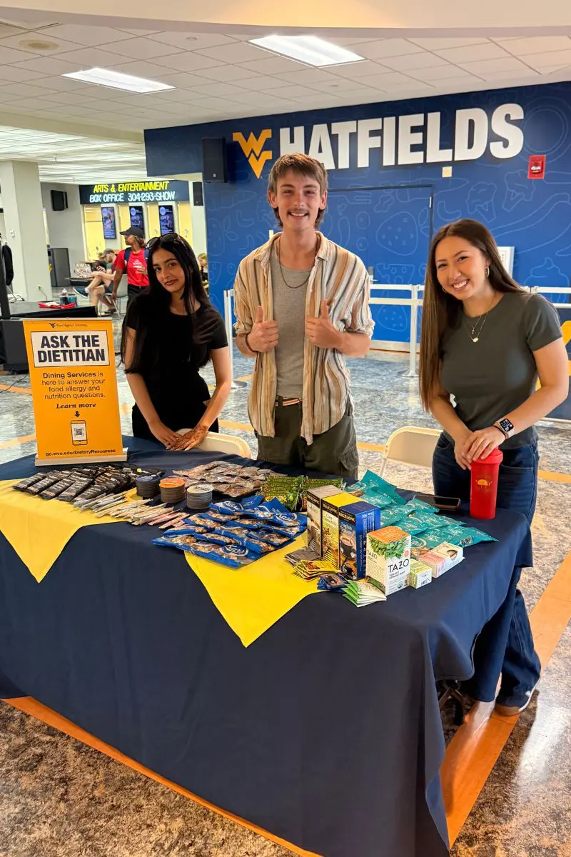 students/staff working a dietitian table event