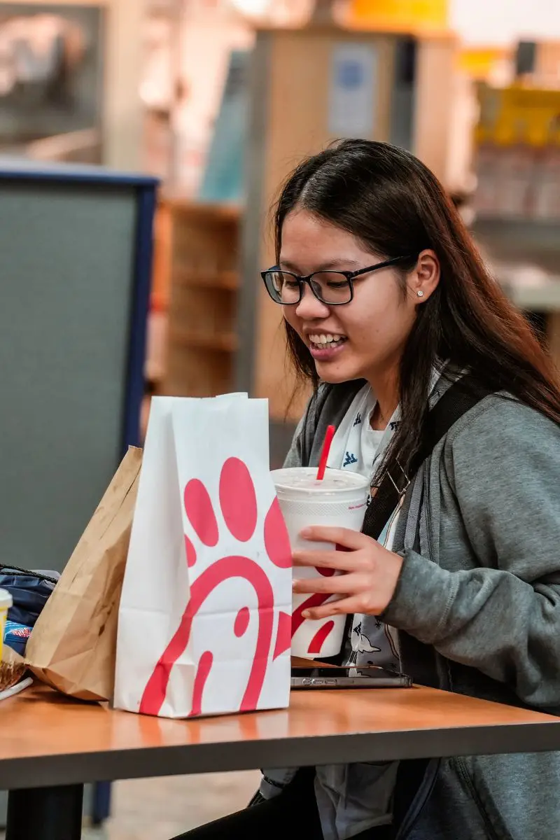 Student sitting at a dining table with chick-fil-a